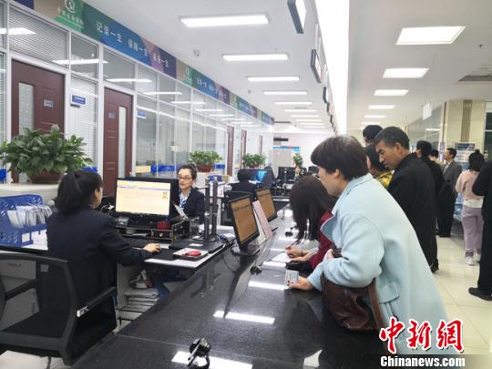 图为民众在窗口办理业务。　杨娜 摄